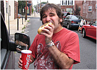 Aaron eats a Philly cheesesteak.